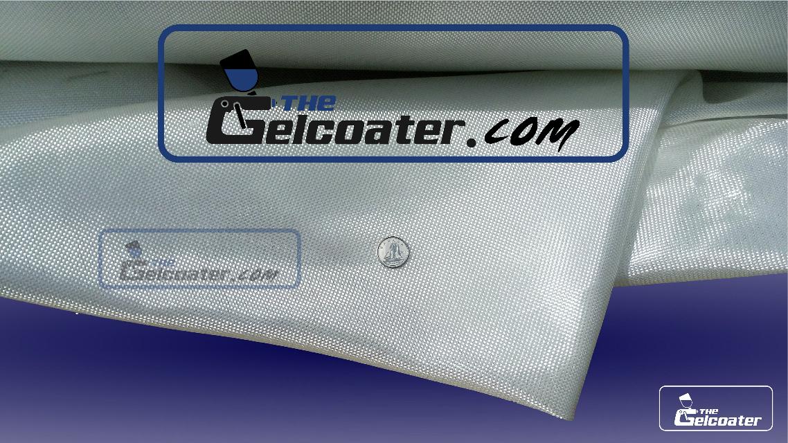 the gelcoater dot com logo with a dime on top of shimmering folded fiberglass cloth to show the fineness and tightness of the cloths weave