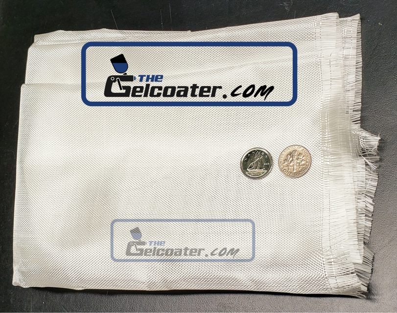 a piece of folded 3.25 ounce per square yard fiberglass cloth with 2 dimes on it to show the tightness of the weave with The Gelcoater.com logo